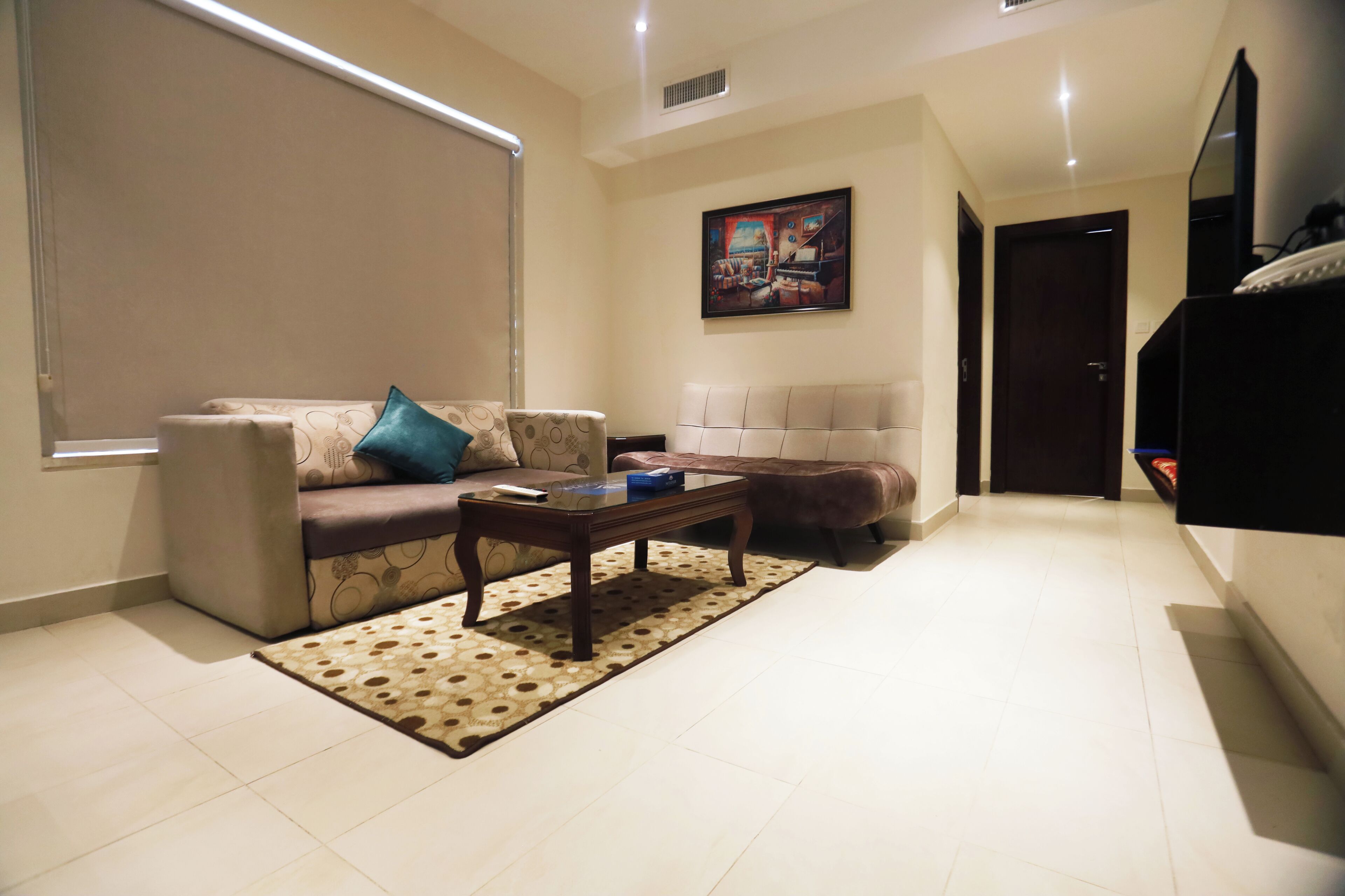 A living room with a sofa, a coffee table, and a patterned rug.