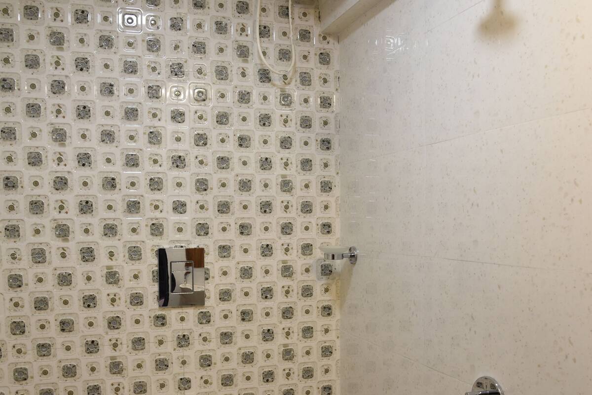 A bathroom with a toilet, sink, and shower.
