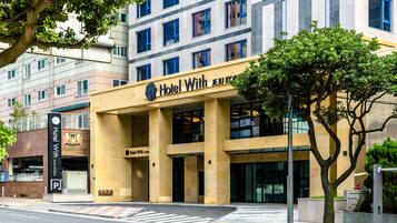 A hotel with a modern facade, multiple floors, and a prominent entrance.