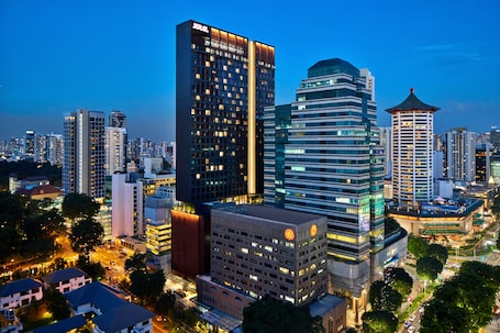 A high-rise hotel with multiple floors, a prominent entrance, and a modern architectural design.