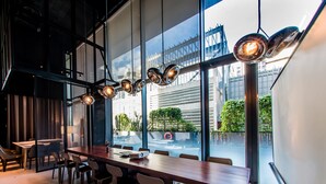 A modern conference room with a long table, chairs, and a projector. - YOTEL Singapore Orchard Road (Singapore)