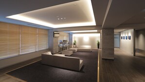 A modern interior with a sectional sofa, a dining area, and a wall-mounted TV. - Kisarazu Washington Hotel (Kisarazu)