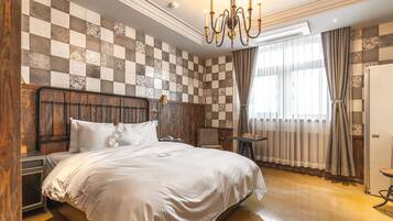 A spacious bedroom with a large bed, wooden headboard, and a checkered wall pattern.