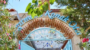 A traditional Mediterranean-style entrance with a blue door and a decorative archway. - Degirmenli Konak (Cesme)
