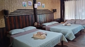 A room with two beds, wooden headboards, and a woven wall. - Kopi Doki Guest Haus (Coron)