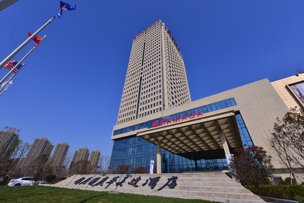 A modern building with a prominent entrance and a sign in a foreign script.