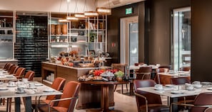 A modern restaurant with a brick wall, wooden counter, and leather chairs. - Bat Sheva Jerusalem By Jacob (Jerusalem)