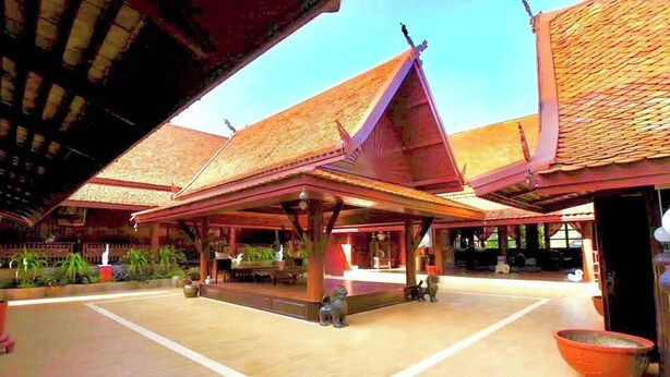 A traditional building with a tiled roof, open central area, and wooden pillars. - Viewdoi Art and Resort by Zuzu (Chiang Mai)