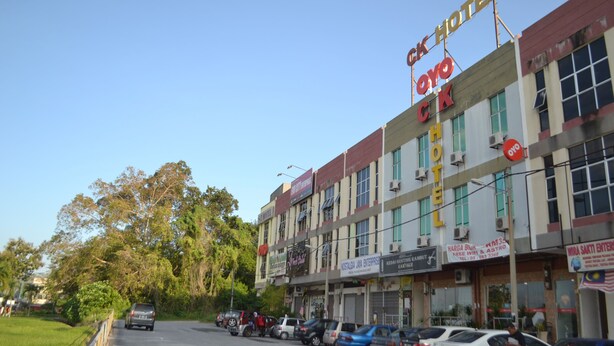 A hotel with multiple signs, including 'OYO HOTEL' and 'NOSTALGIA JAYA ENTERPRISE'. - OYO 89715 CK Hotel 2 (Lumut)