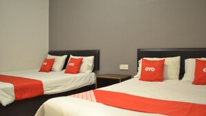 A hotel room with two beds, each with a red and white bedspread and matching pillows. - OYO 89715 CK Hotel 2 (Lumut)
