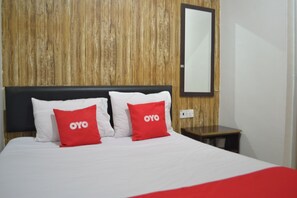 Cozy retreat with a comfortable bed, large mirror, and convenient nightstand.