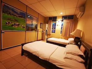 A hotel room with two beds, a large window with curtains, a wall-mounted TV, and a ceiling fan. - Masada Bed And Breakfast (Kota Kinabalu)