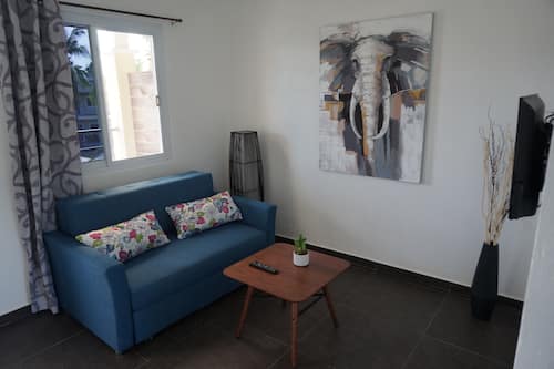 Queen Suite with Pool View | Living area | LED TV