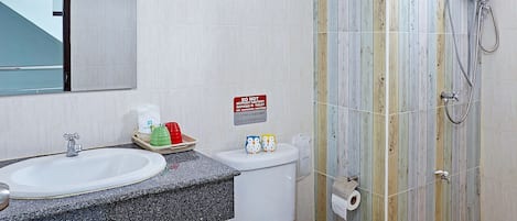 A bathroom with a sink, toilet, and shower.