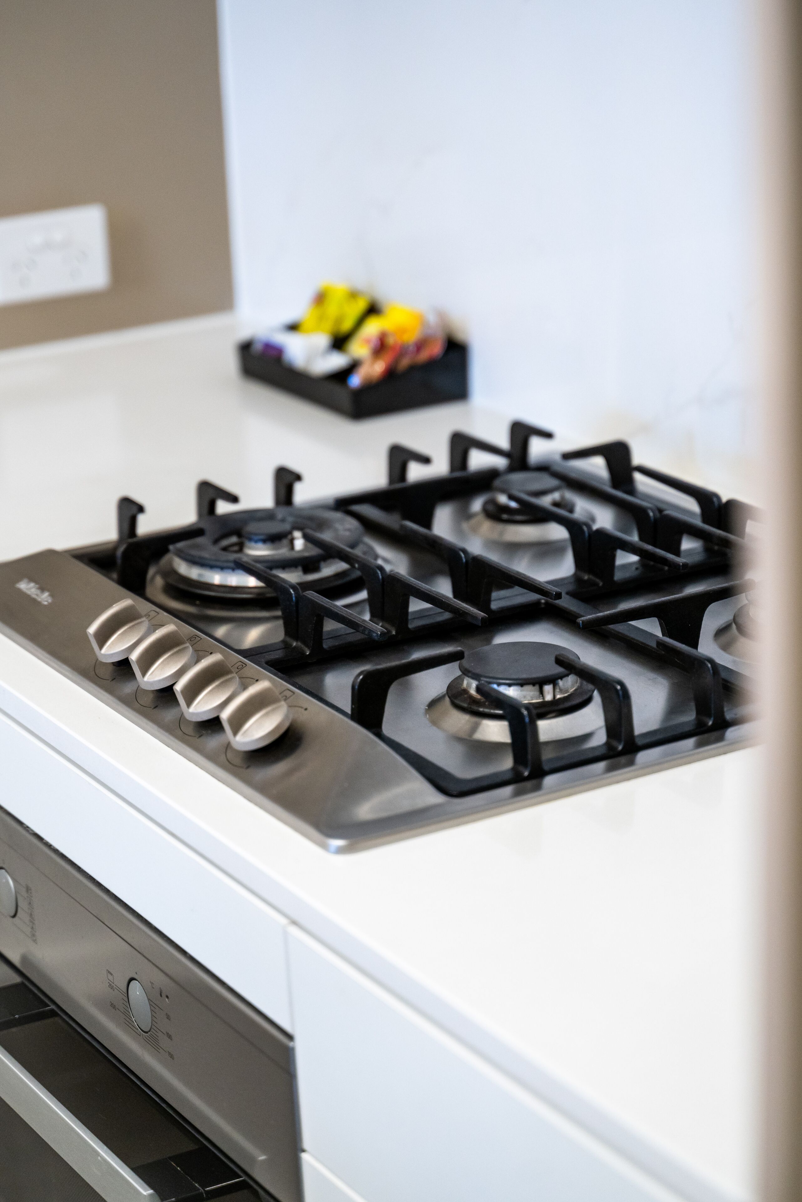 A kitchen with a white stove and black burners.