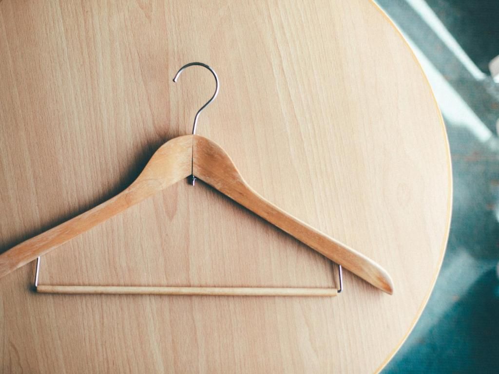 A wooden hanger on a round table.