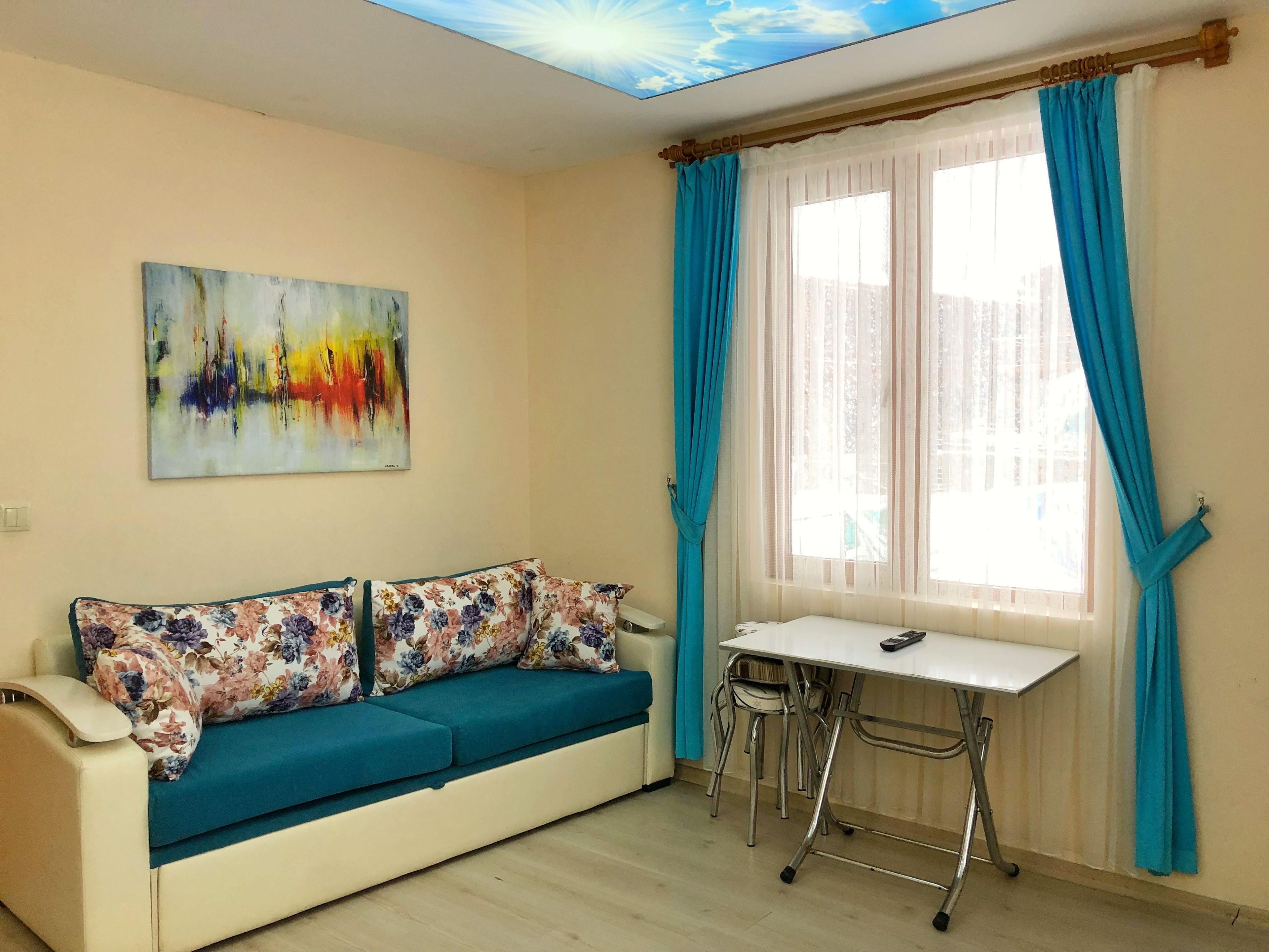 A room with a sofa, a table, and a chair.