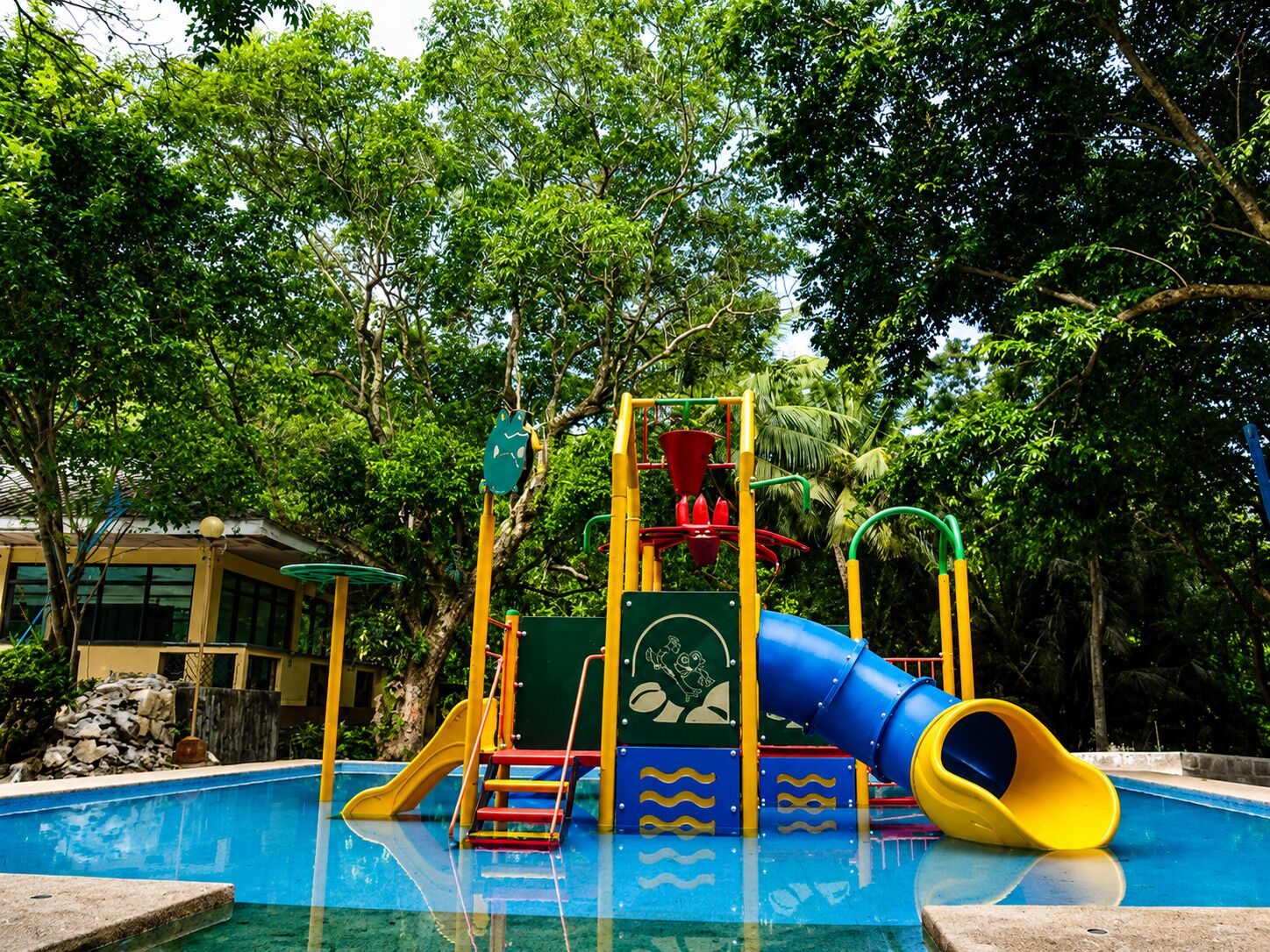 A children's playground with a slide and climbing structures.