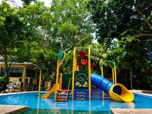 A children's playground with a slide and climbing structures. - Ouans The Farm Resort Lucena City (Lucena)