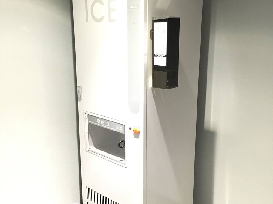 A white, standalone ice machine with a digital display, a control panel, and a door with a sign indicating it is for internal use.