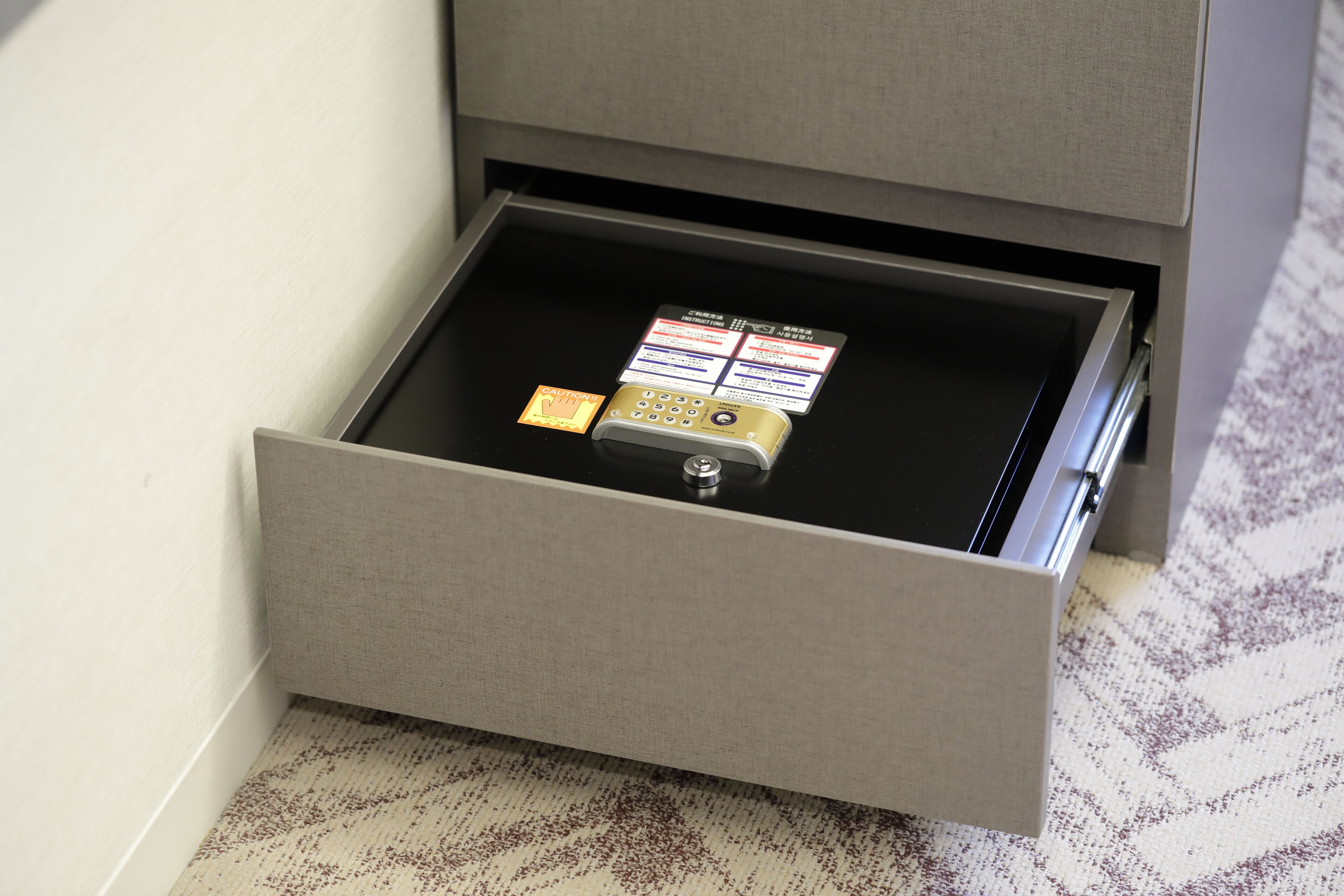 Un tiroir avec un cadenas et une carte à l’intérieur.