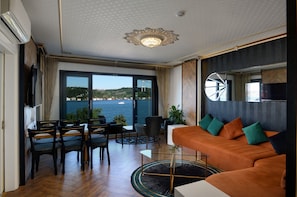 Family Condo, 2 Bedrooms, Sea View, Beachfront | Living area | 42-inch Smart TV with satellite channels, TV, heated floors
