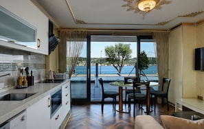 Panoramic Suite, 1 Bedroom, Sea View | Living room | 42-inch Smart TV with satellite channels, TV, heated floors