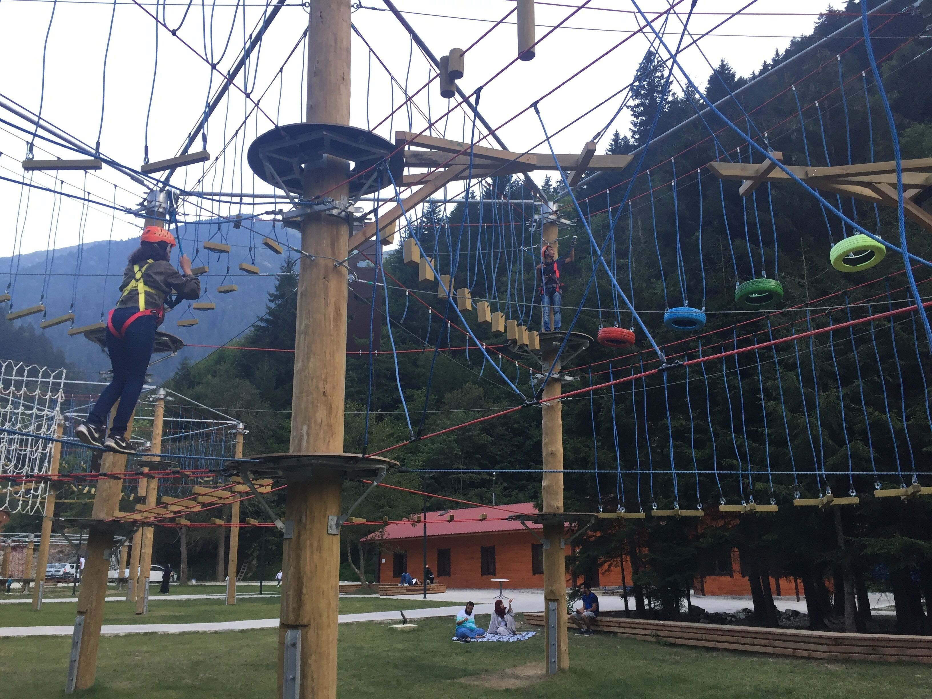 An outdoor adventure course with wooden structures and ropes.