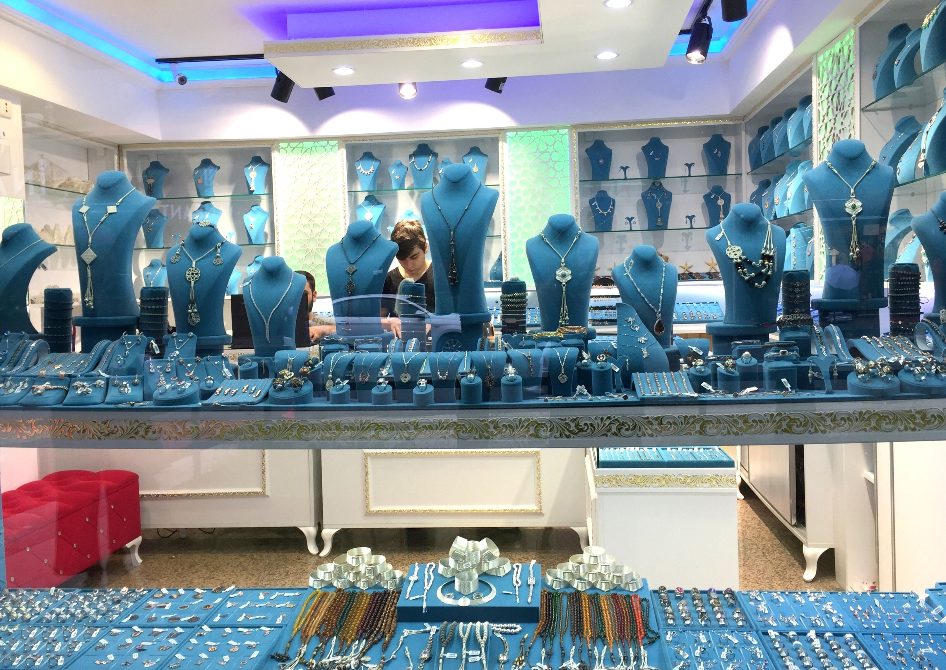 A jewelry store with multiple display cases and a variety of jewelry items.