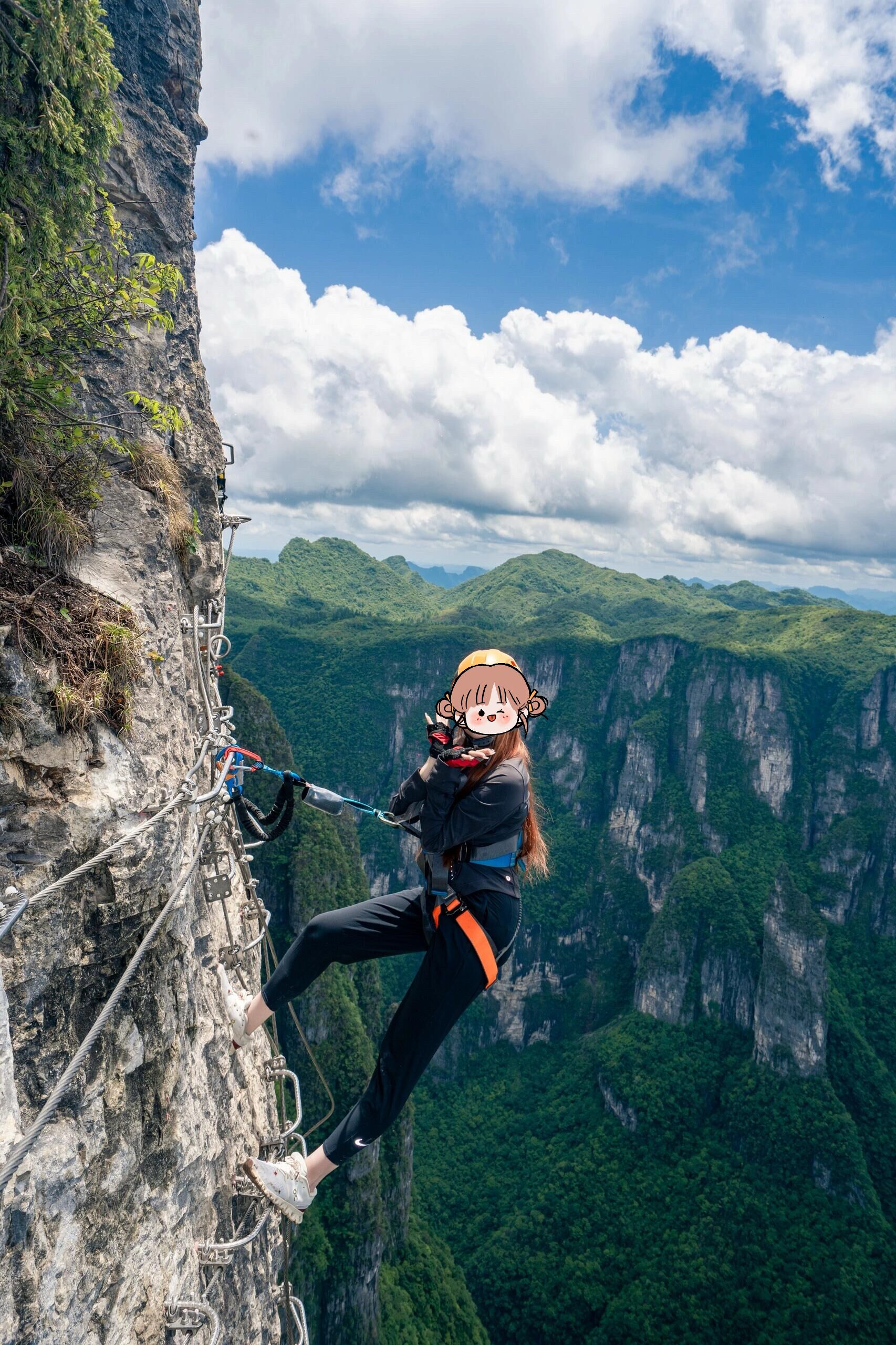 A person bungee jumping from a cliff with a mountainous landscape in the background.
