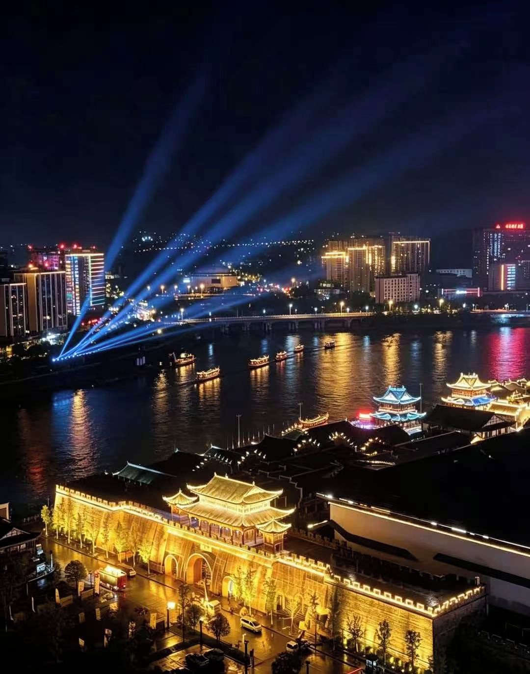 A nighttime cityscape with illuminated buildings, a river, and traditional architecture.