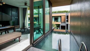 A modern interior with a dining area, a pool, and a view of the outside.
