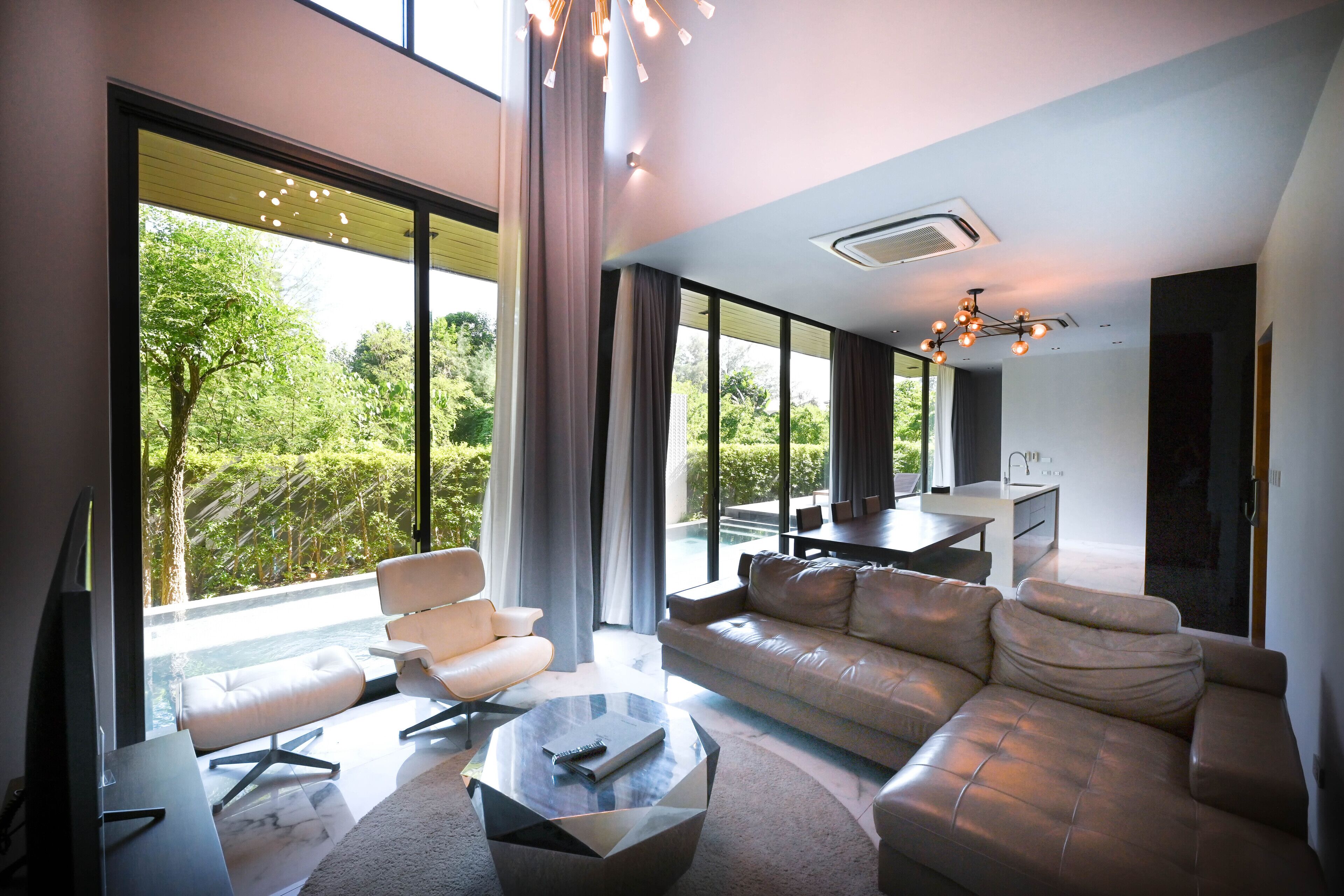 A modern living room with a sofa, armchair, and coffee table.