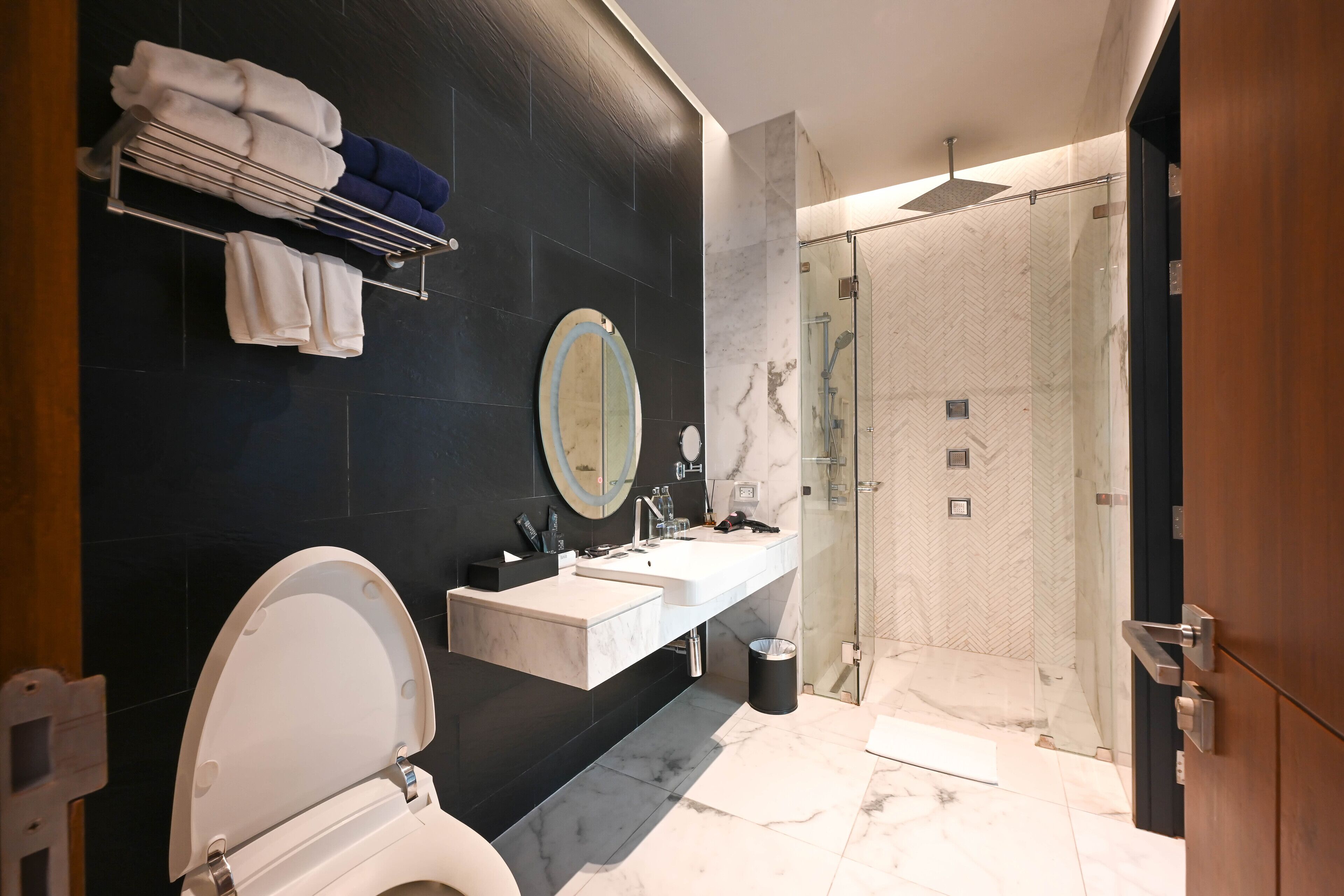 A modern bathroom with a toilet, sink, and shower.