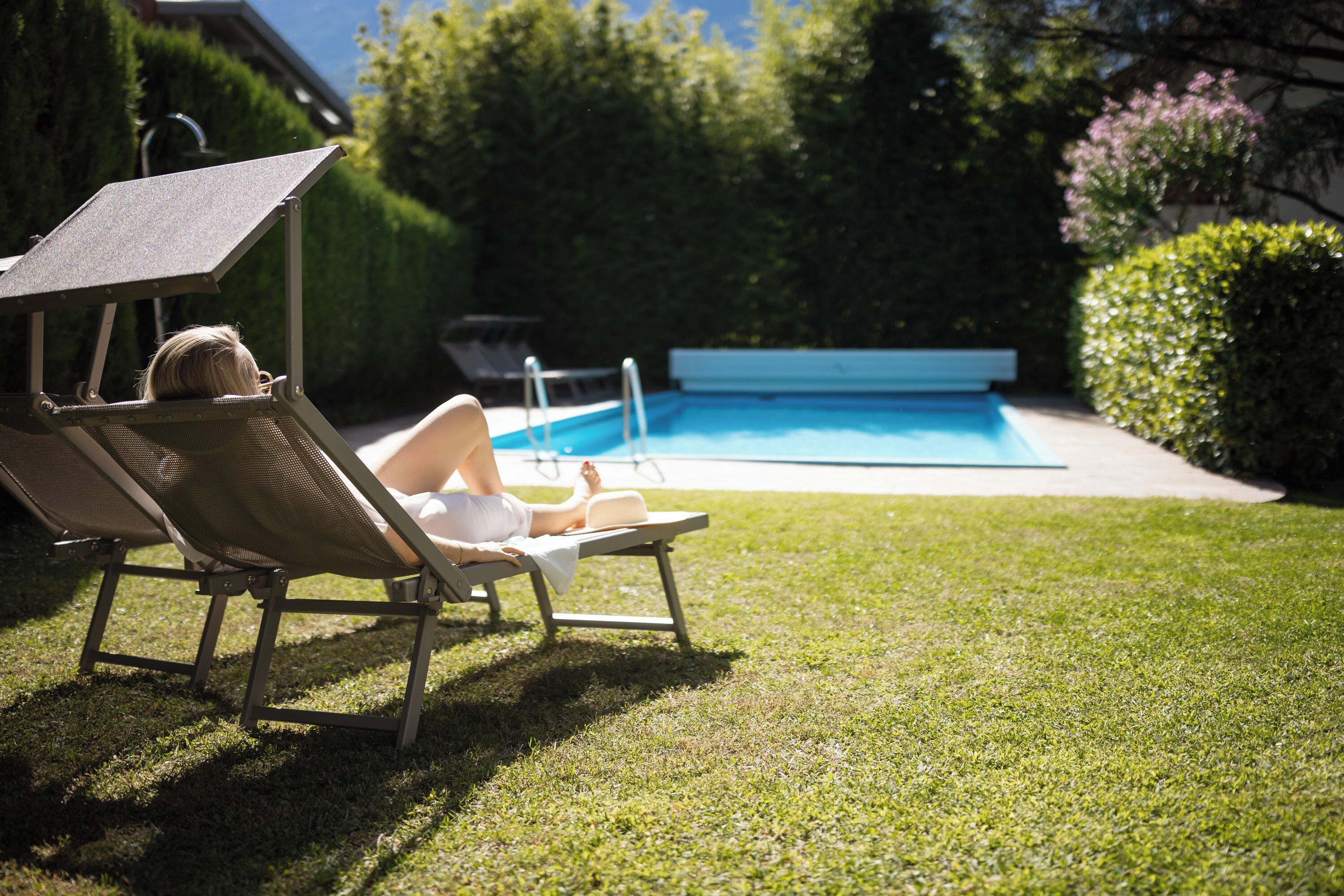 A poolside area with lounge chairs and a swimming pool.
