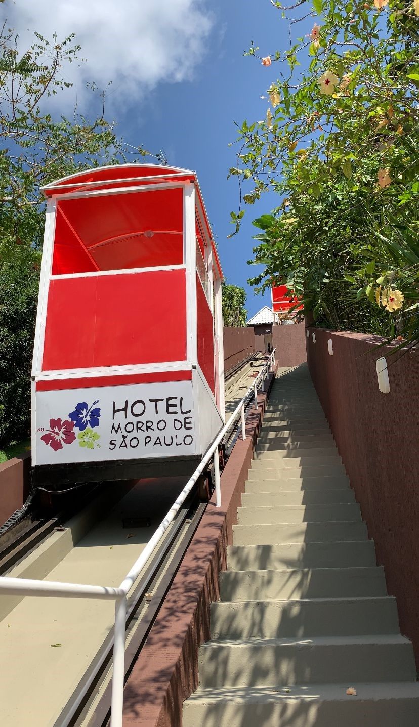 Un carrito de hotel rojo y blanco en una escalera con un letrero que dice "HOTEL MORRO DE SAO PAULO".