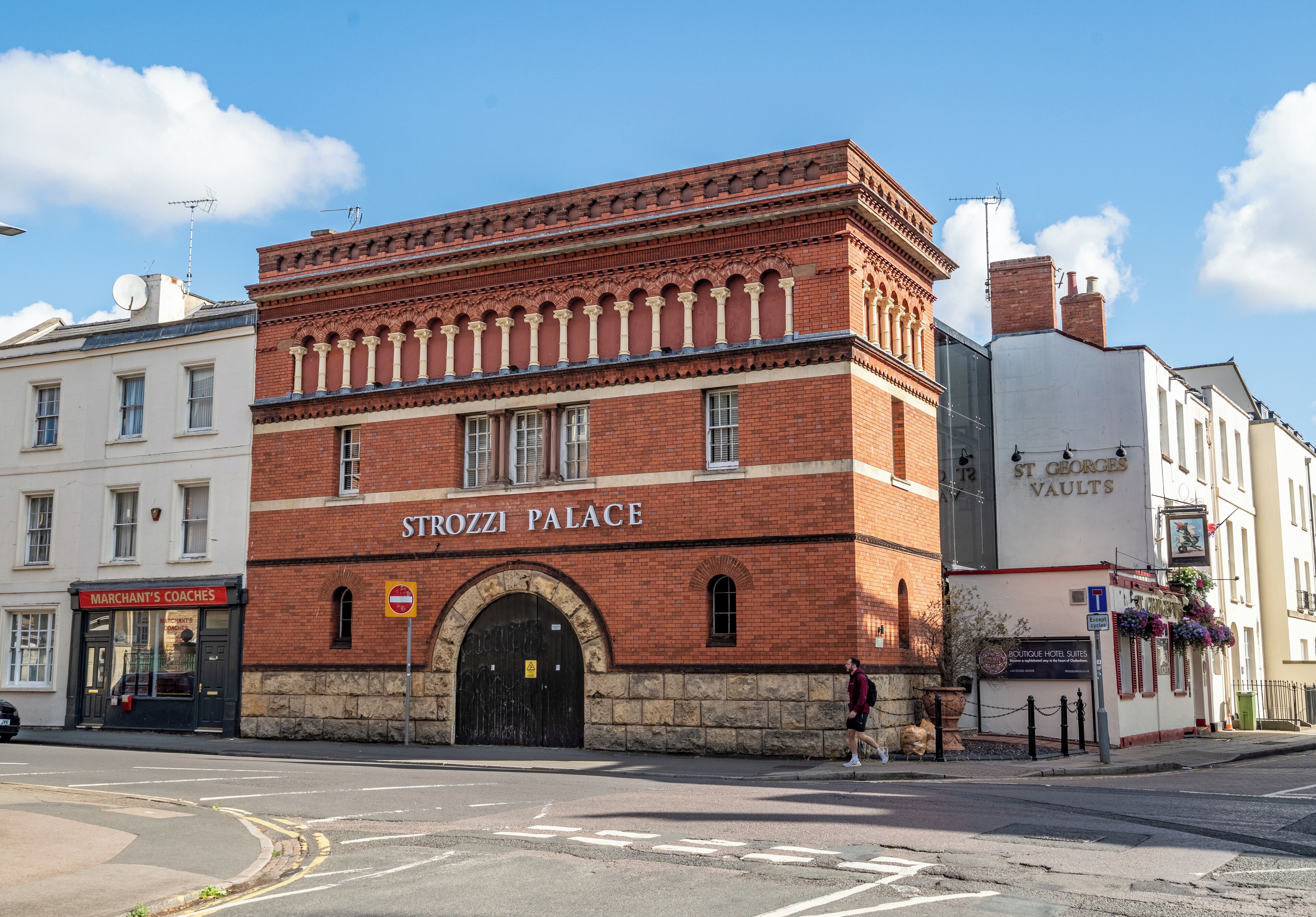 A red brick building with the sign 'STROZZI PALACE' indicating a hotel.