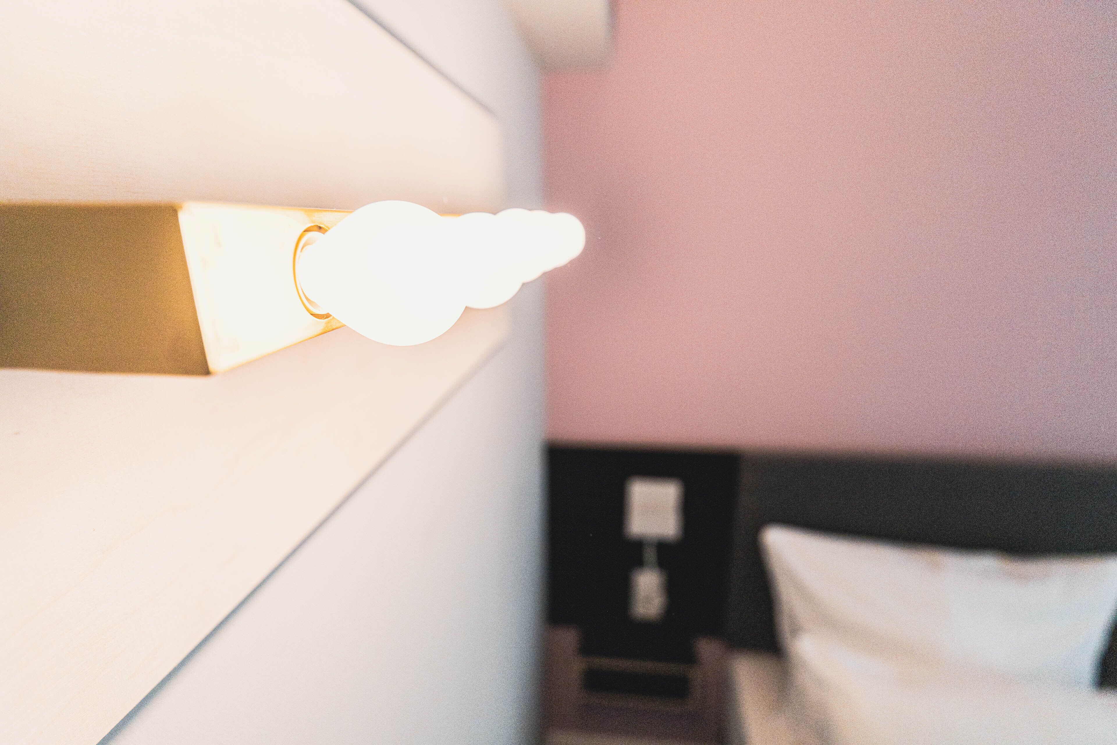 A wall-mounted light fixture with a cloud-shaped design.