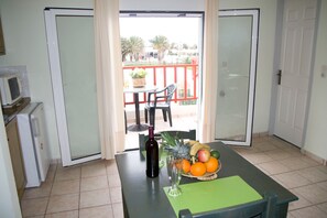 Apartment, Sea View | Living area | Flat-screen TV