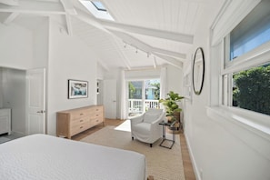 A bedroom with a bed, a dresser, a chair, a plant, and a window with a view of the outdoors. - Cycle or Walk to Hanalei Bay (Hanalei)