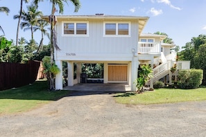 A two-story house with a garage, a covered driveway, and a fenced backyard. - Cycle or Walk to Hanalei Bay (Hanalei)