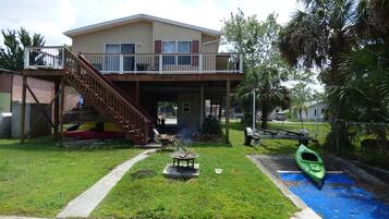 Enjoy a peaceful stay with a balcony overlooking the serene lawn and kayak dock.