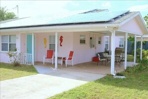 Tiled carport also serves as a covered patio with grill and table and chairs. 