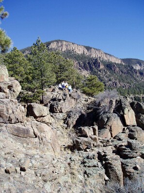 A rocky terrain with a group of people sitting on a rock formation. - Perfect Home for Large Family Gatherings in South Fork/Creede Colorado all year (South Fork)