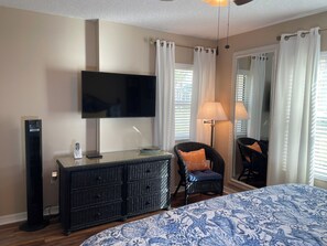 A hotel room with a bed, a television, a desk with a lamp, a chair, and a dresser. - Ocean Village Club R17 Exceptionally Clean! On the Beach! OVER 280 "5 STARS" (St. Augustine)