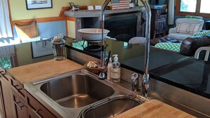A kitchen with a double sink, wooden countertops, and a built-in oven. - Walk to Private Beach, Great screened porch, Chefs kitchen, Open beam design (Union Pier)
