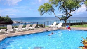 A swimming pool with lounge chairs and a view of the ocean. - Ocean Front Napili Point C20 Amazing View  A/C  Freshly Remodeled for 2025! (Napili, Lahaina)