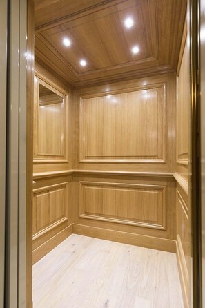 A room with wooden paneling, recessed ceiling lights, and a light-colored wooden floor. - Perfect Amazing Penthouse for 2-Balcony-Ile de la Cite-AC-Wifi-Lift-Cafes (Paris)