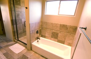 Combined shower/bathtub, hair dryer, towels, soap