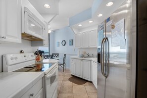 Enjoy cooking and dining in this well-equipped kitchen with a microwave, oven, and refrigerator.